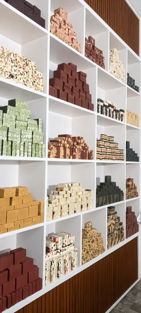 Shelves filled with genuine small-batch Greenwings soaps in the workshop